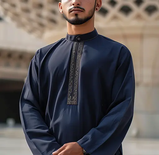 Man posing in traditional setting wearing Al-Dar Apparel's Moroccon Thobe.